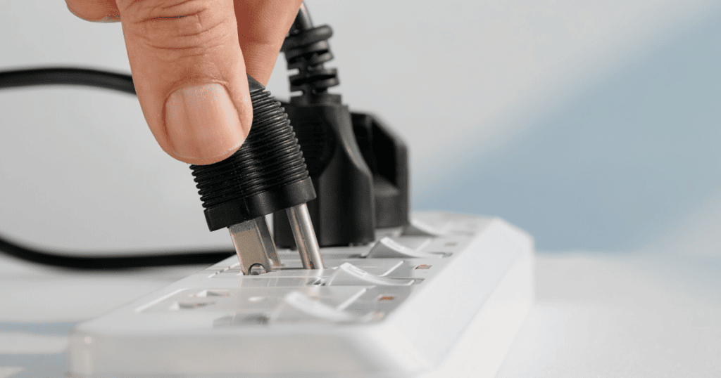 Person Plugging In Power Cord