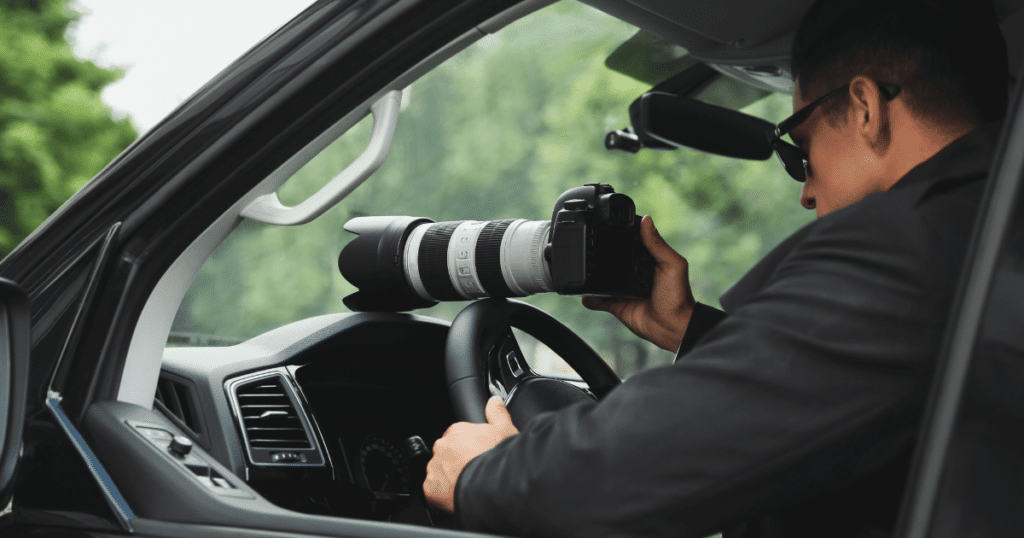 Private Investigator Taking Photo From Vehicle